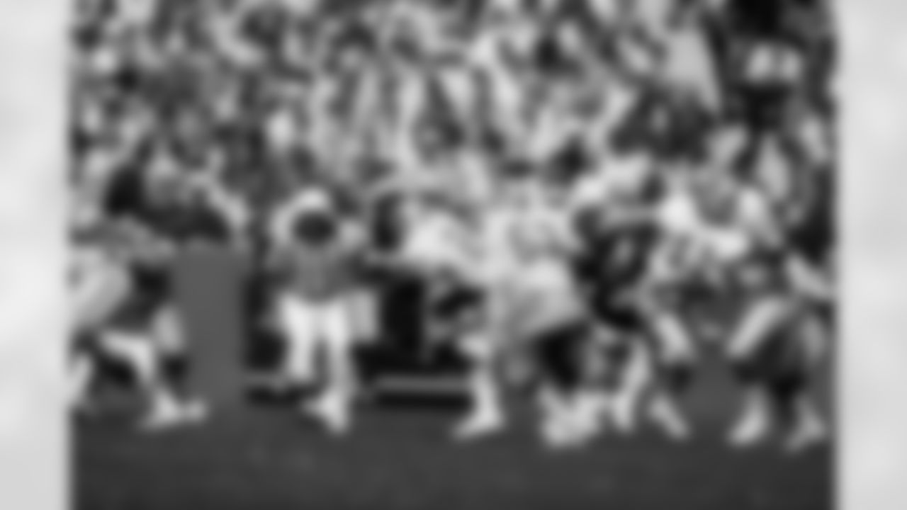 Detroit Lions quarterback Greg Landry (11) rolls out to pass after faking a handoff to running back Dexter Bussey (24) during an NFL game against the Green Bay Packers in Green Bay, Wis., Oct. 3, 1976. The Packers defeated the Lions 24-14. (AP Photo/Vernon Biever)