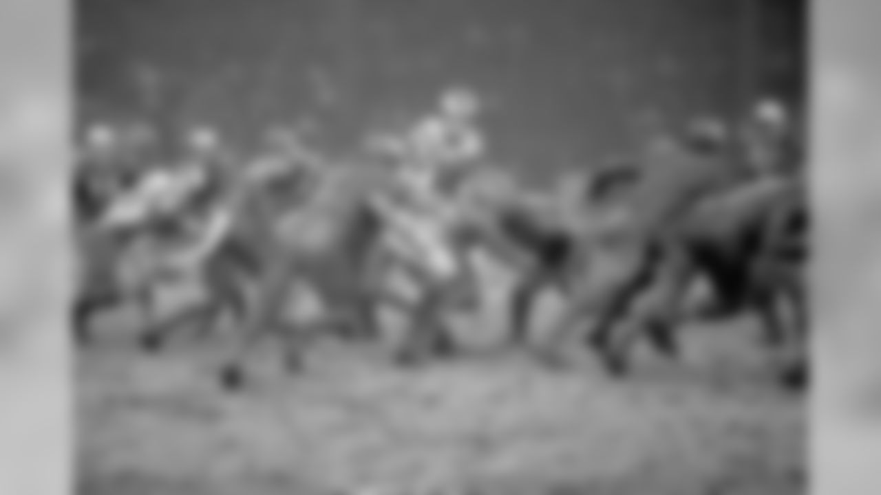 Playing conditions were far from ideal in the Thanksgiving Day contest between the Philadelphia Eagles and the Detroit Lions in Detroit on Nov. 28, 1968. There was no distinguishing the muddy players as the game progressed on the rain-soaked field. Managing to keep fairly clean, he was rarely spilled, was Eagle quarterback Norm Snead (16), preparing to hand off the ball in the fourth quarter. Philadelphia won the game 12-0. (AP Photo/Alvan Quinn)