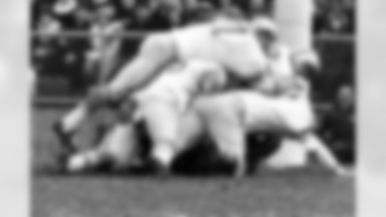 Detroit Lions defensive tackle Alex Karras (71) is part of the pile that buries Green Bay Packers quarterback Bart Starr during a 12-7 Lions victory on November 7, 1965, at Lambeau Field in Green Bay, Wisconsin. (AP Photo/Vernon Biever)
