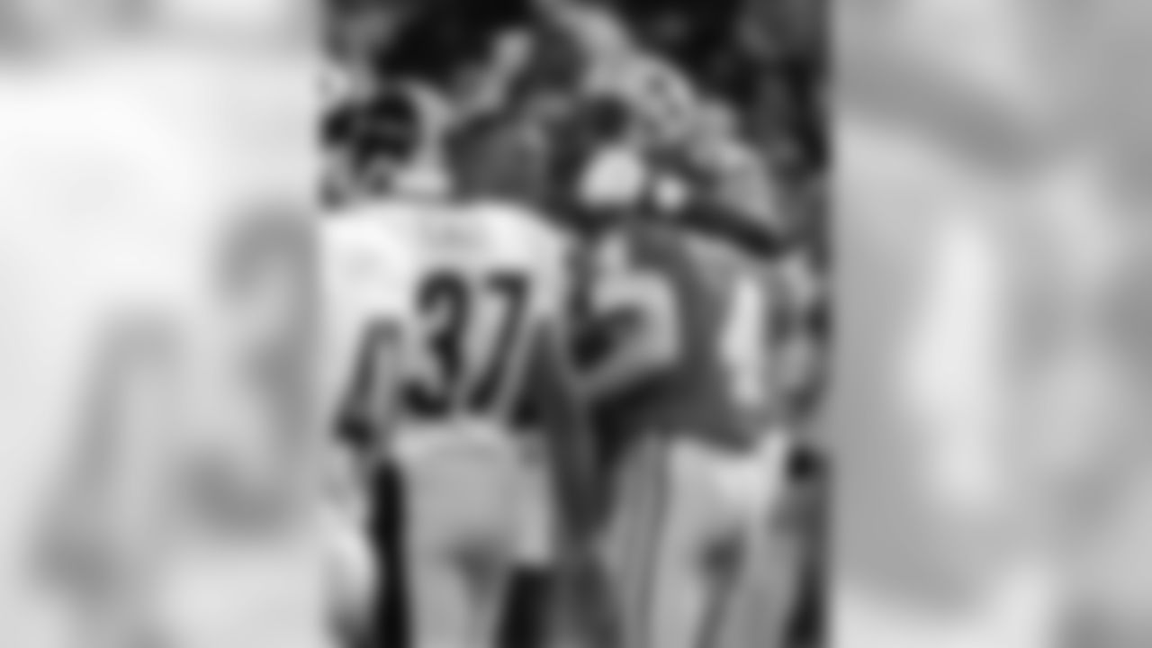 * FILE *Pittsburgh Steelers cornerback Carnell Lake (37) walks off the field as the Detroit Lions congratulate Lions placekicker Jason Hanson (4) after his overtime kick to defeat the Steelers 19-16 at the Silverdome in Pontiac, Mich., Thursday, Nov. 26, 1998. (AP Photo/Carlos Osorio)