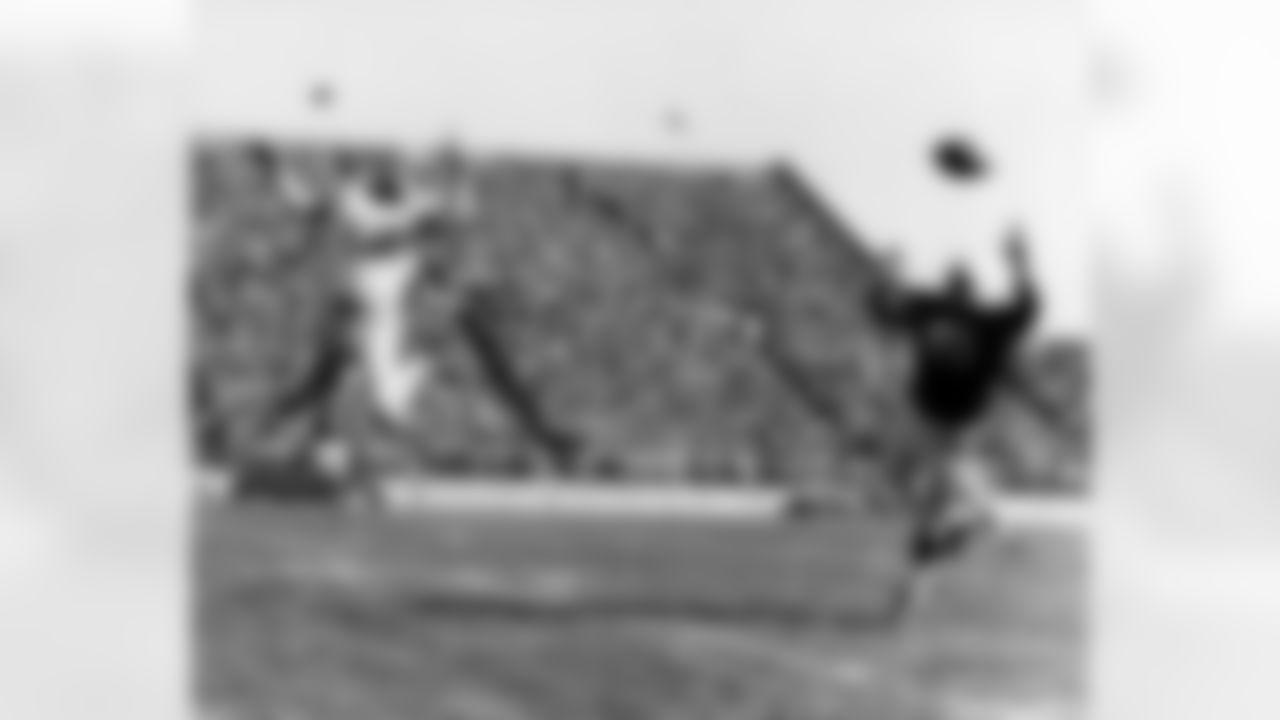 Detroit Lions halfback Howard "Hopalong" Cassady (40) misses a pass intended to him as Green Bay Packers cornerback Hank Gremminger (46) defends during an NFL game in Green Bay, Wisc., on Oct. 6, 1957. The Lions defeated the Packers 24-14. (AP Photo/Vernon Biever)