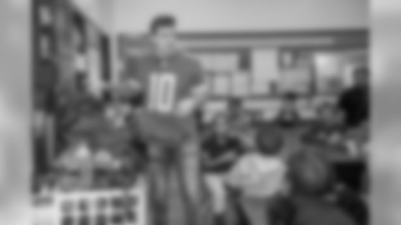 Detroit Lions quarterback David Blough (10) distributes gifts to students at Mary McLeod Bethune Elementary-Middle School Tuesday, Dec. 10, 2019 in Detroit.