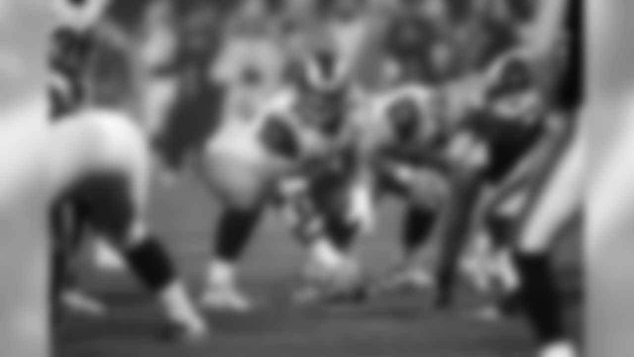 Hank Fraley #65 of the St. Louis Rams looks over the defense prior to a play against the Cleveland Browns at Cleveland Browns Stadium on August 21, 2010 in Cleveland, Ohio. The Rams defeated the Browns 19-17. (AP Photo/G. Newman Lowrance)