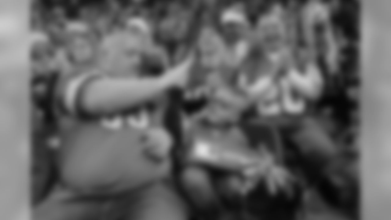 A fan receives a surprise from Santa Claus during a NFL football game against the Minnesota Vikings on Sunday, Dec. 23, 2018 in Detroit. (Detroit Lions via AP).