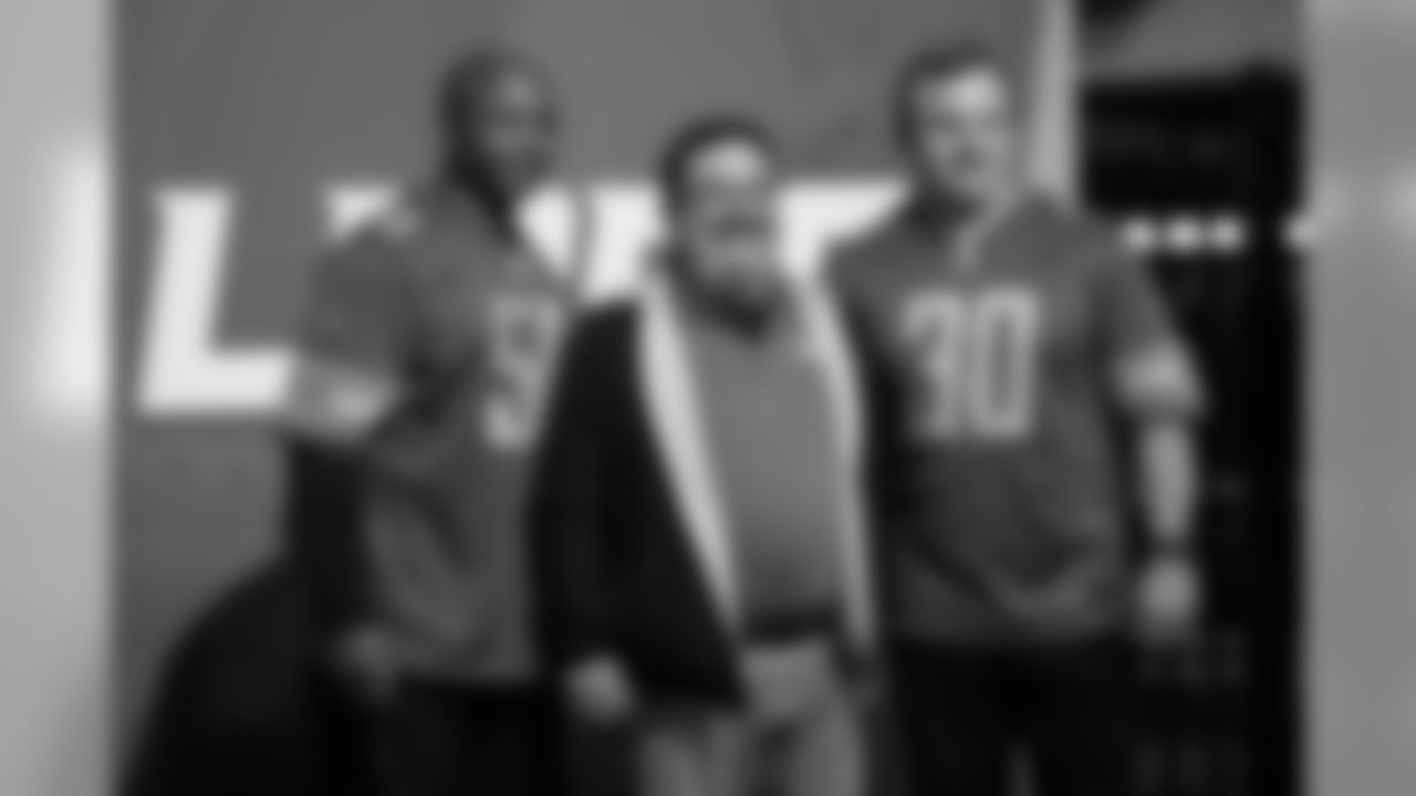 A fan takes a photo with Lions Legends at the Season Ticket Member Summit on Monday, Feb. 11, 2019 in Detroit.