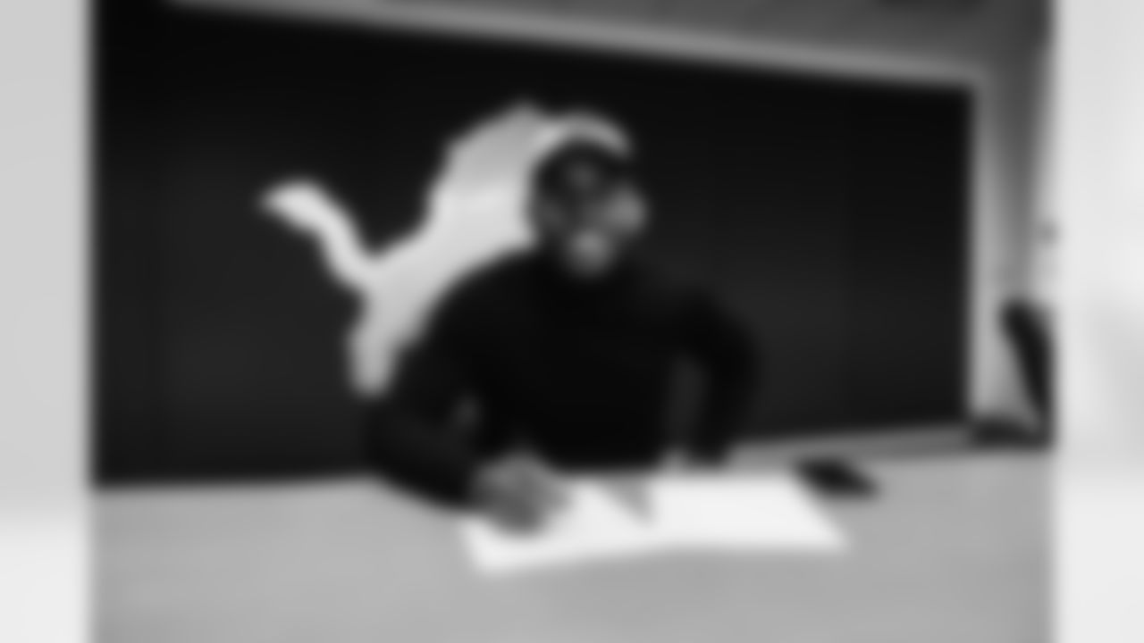 Detroit Lions safety C.J. Moore (38) signing his contract at the Training Facility in Allen Park, MI on March 14, 2022. (Jeff Nguyen/Detroit Lions)
