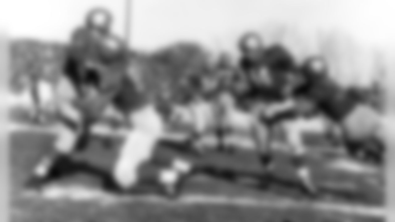 Detroit Lions halfback Bob Hoernschemeyer (14) tries to avoid a tackler during a 24-17 victory over the Green Bay Packers on Nov. 4, 1951, at City Stadium in Green Bay, Wisconsin. (AP Photo/Vernon Biever)