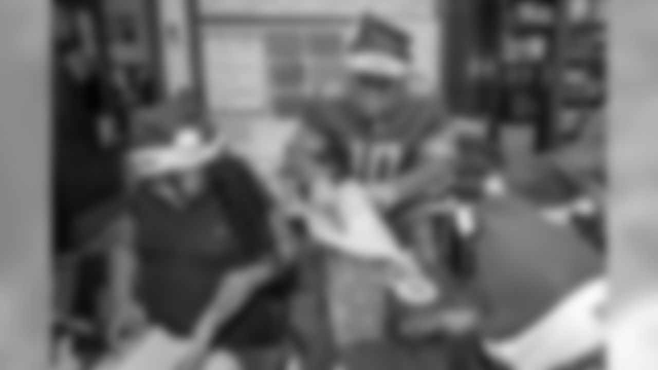 Detroit Lions quarterback David Blough (10) distributes gifts to students at Mary McLeod Bethune Elementary-Middle School Tuesday, Dec. 10, 2019 in Detroit.