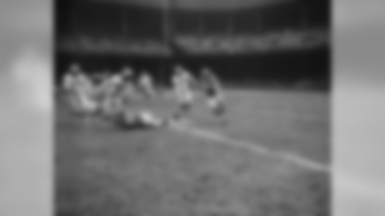 Doak Walker, flashy Detroit Lions back, carries the ball for a five yard gain against the New York Yanks while getting little help from teammates Lou Creekmur (76), tackle, and Ollie Cline (30), back, in second quarter of game played in Detroit on Nov. 23, 1950. Getting set to make the tackle are Yanks Joe Domnanovich (34), center, and Sherman Howard (46), back. No. 50 is New York end John Yonakor. Lions won 49-14. (AP Photo/Preston Stroup)