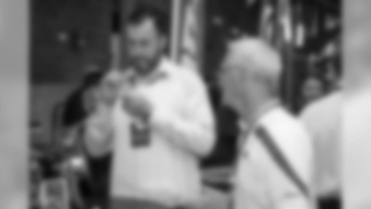 Don Muhlbach signs a wine glass at Taste of the Lions on Wednesday, May 15, 2019 in Detroit.