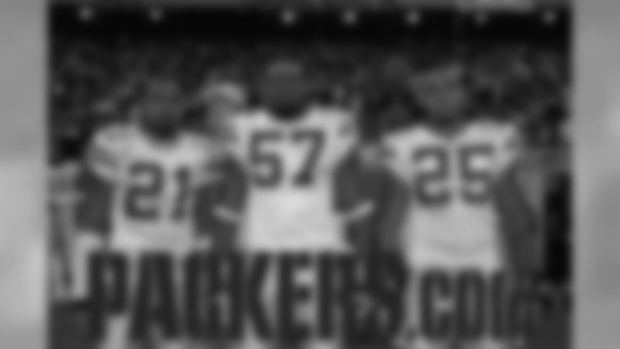 Nov. 22, 2007 - Aaron Rodgers photo-bombs a captains photo featuring DB Charles Woodson (21), DE Jason Hunter (57) and RB Ryan Grant (25).