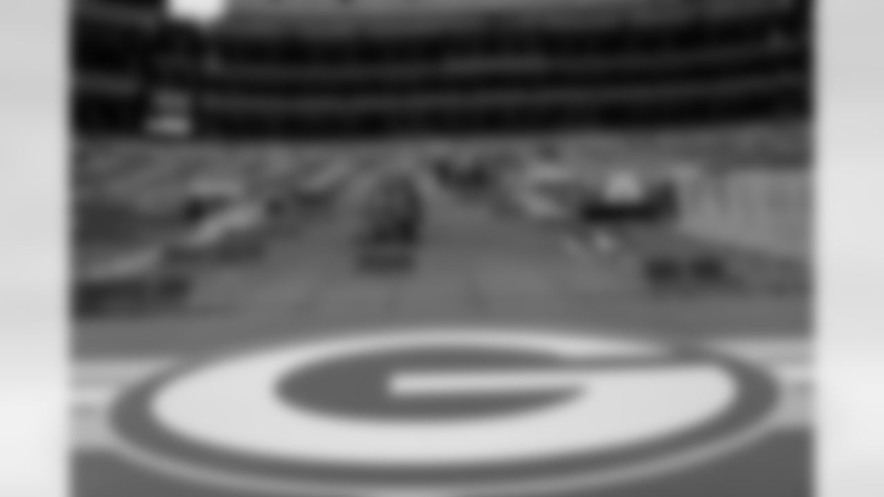 Fans take their socially distanced seats before an NFL divisional playoff football game between the Los Angeles Rams and Green Bay Packers, Saturday, Jan. 16, 2021, in Green Bay, Wis.