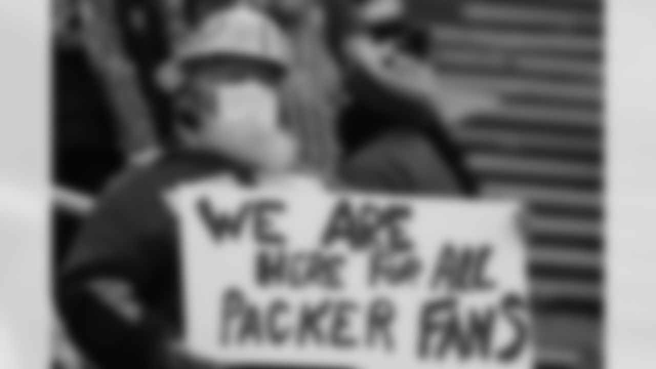 A Packers' fan waits for the start of an NFL divisional playoff football game between the Los Angeles Rams and Green Bay Packers, Saturday, Jan. 16, 2021, in Green Bay, Wis.