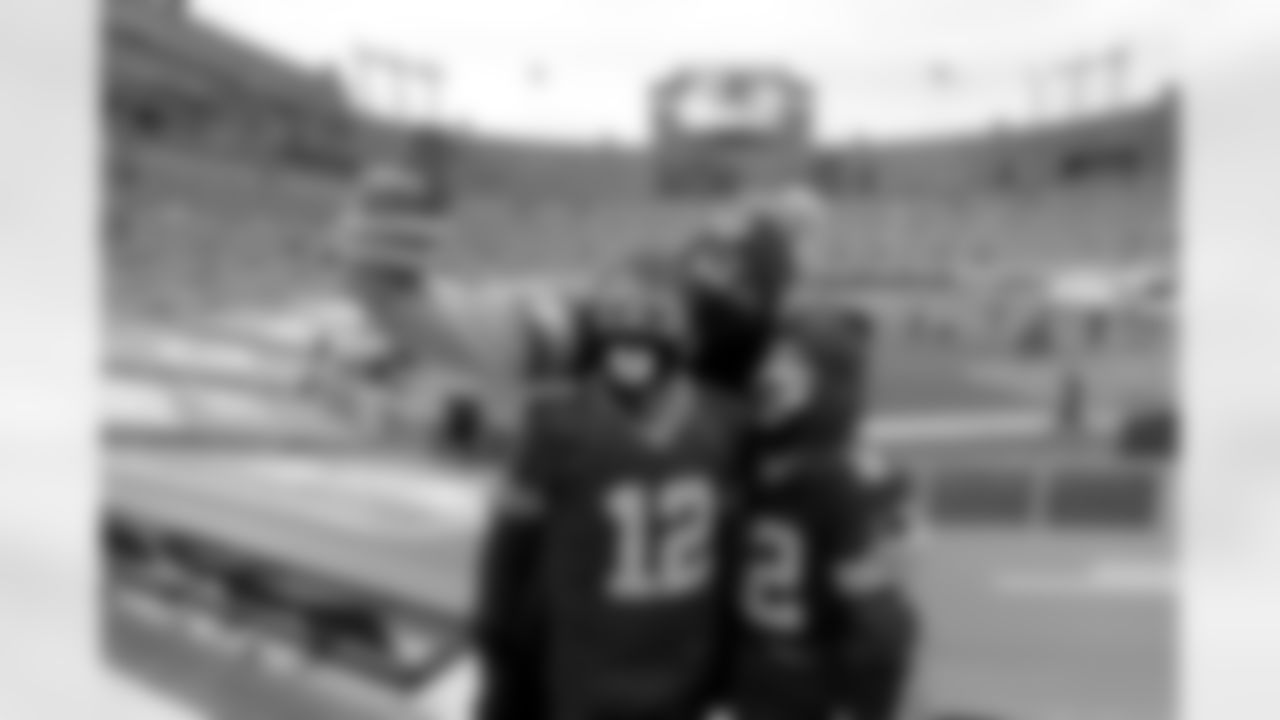 David Keane takes a photo of his son Wyatt, right, and friend, Drew Thomas before an NFL divisional playoff football gme between the Los Angeles Rams and Green Bay Packers, Saturday, Jan. 16, 2021, in Green Bay, Wis.