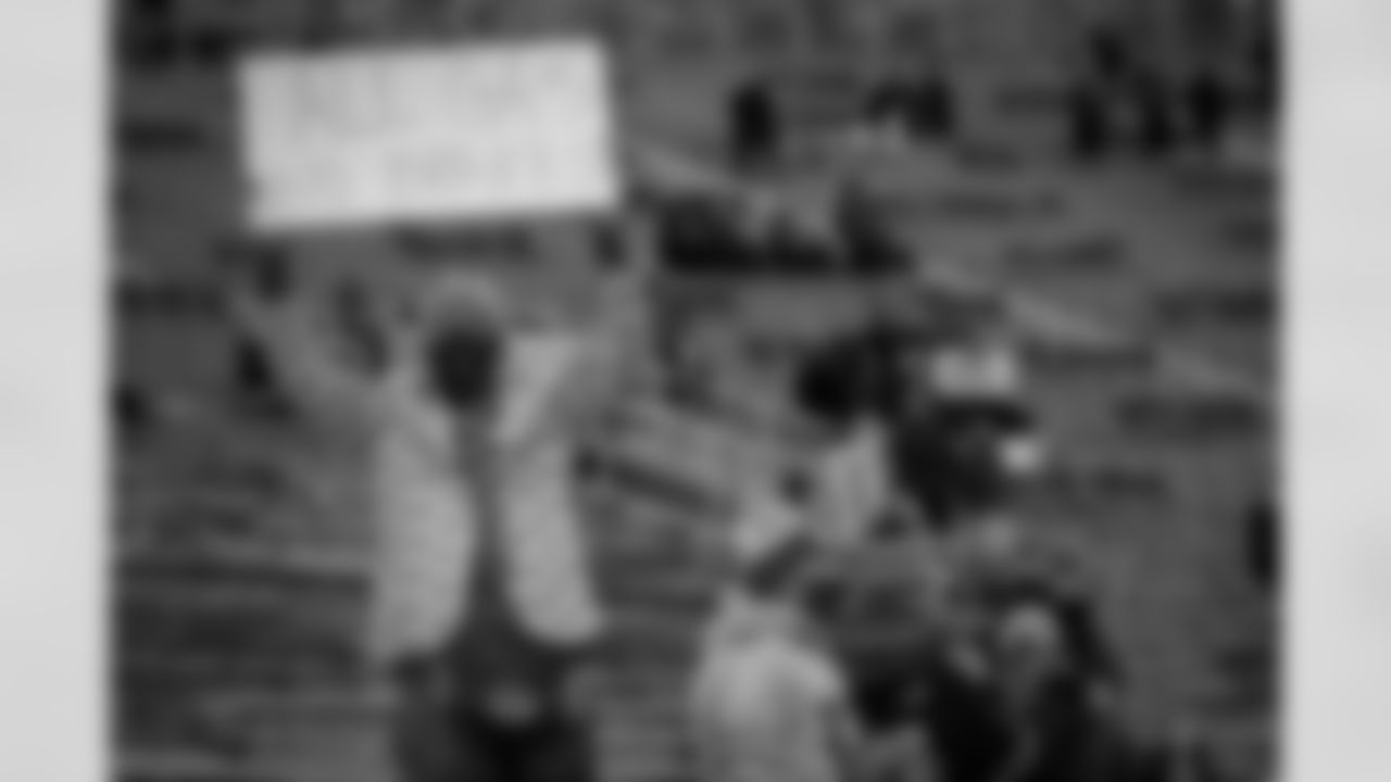 A Green Bay Packers fan holds up a sign before an NFL divisional playoff football game against the Los Angeles Rams, Saturday, Jan. 16, 2021, in Green Bay, Wis.