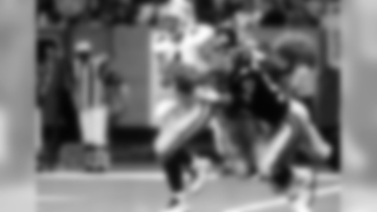 October 4, 1992 - QB Brett Favre pulls out of the grasp of Falcons LB Tim Green while seeking an open receiver at the Georgia Dome in Atlanta. Favre completed a short pass after the scramble.