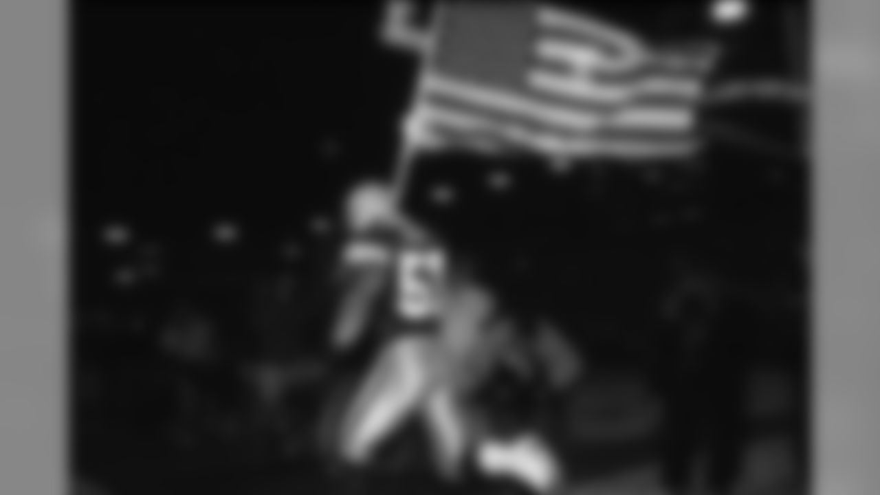 Chris Gizzi, former Packers linebacker (2000-01) lead the team out of the tunnel with an American flag in the first Monday Night Football game played after the 9/11 attacks in 2001. Gizzi was a member of the U.S. Air Force Reserve at the time.