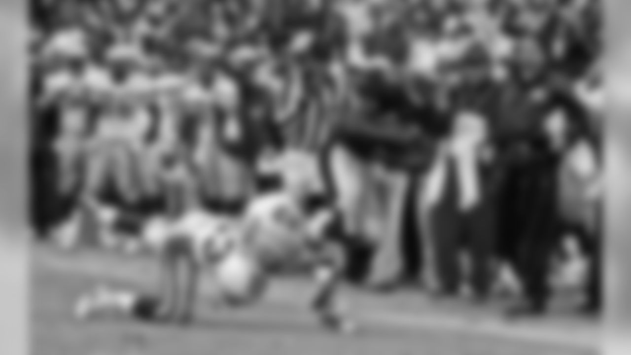 Jan. 11, 1998 - LB George Koonce (53) dives to tackle 49ers FB William Floyd (40) during the NFC Championship game as the sideline looks on. The Packers won, 23-10.