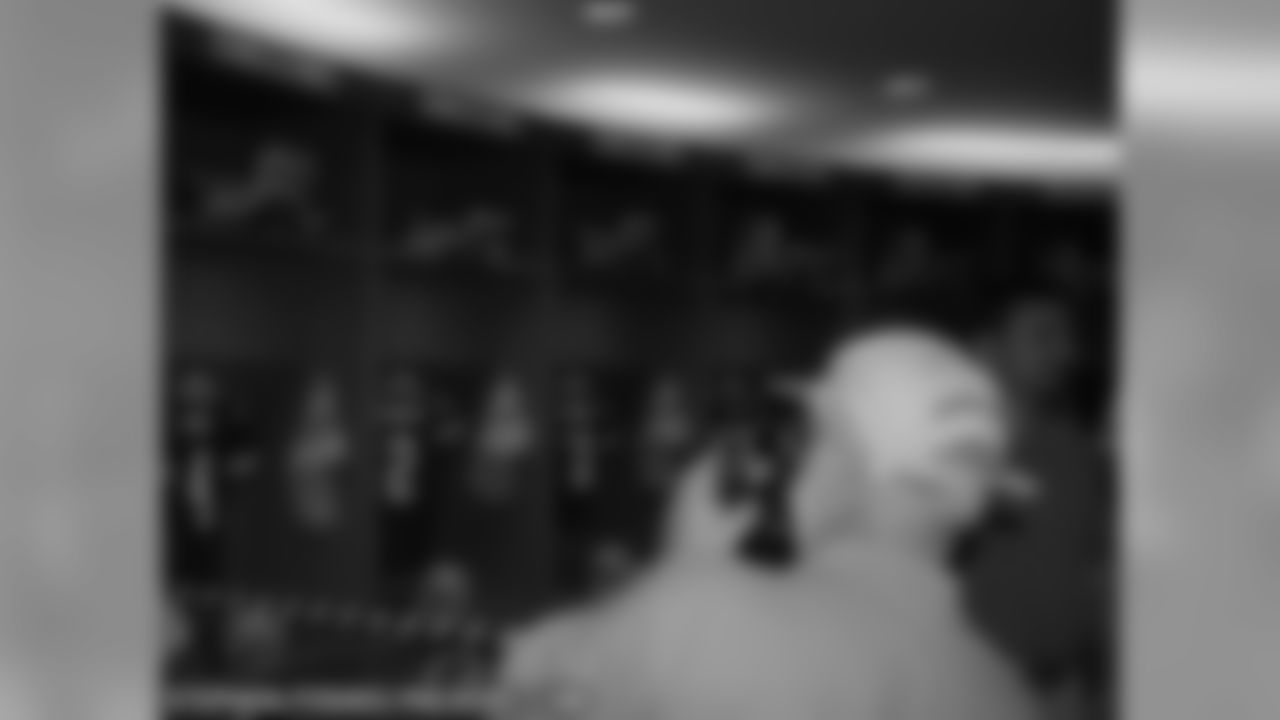 Shareholders tour the Packers locker room.