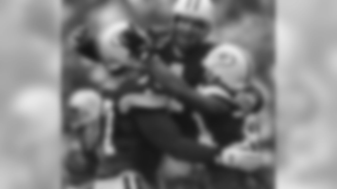 Jan. 4, 1997 - From left, John Michels, Brett Favre and Andre Rison celebrate after WR Antonio Freeman recovered a fumble by teammate Edgar Bennett for a touchdown in the third quarter against the 49ers in Green Bay. The Packers won, 35-14.