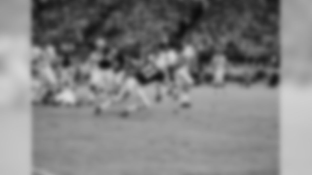 Aug. 18, 1967 - RB Gale Sayers (40) looks to get extra yardage before being brought down by DB Bob Jeter (21) at the Midwest Shrine exhibition game in Milwaukee.