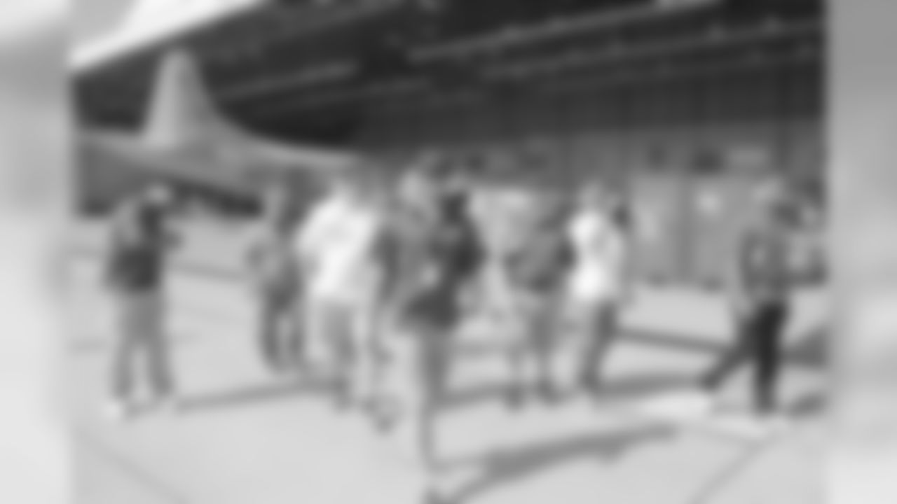 Players and staff walking onto the tarmac at Kadena Air Force Base in Okinawa, Japan.