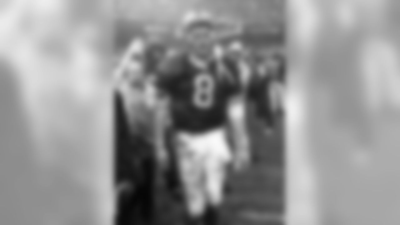 A mud covered Steve Young walks off the field after his San Francisco 49ers lost 23-10 to the Green Bay Packers.