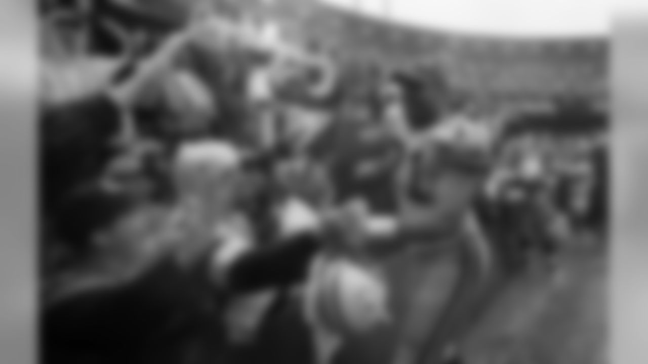 Jan. 11, 1998 - DT Santana Dotson celebrates with Packers fans after defeating the 49ers, 23-10, in the NFC Championship game in San Francisco.