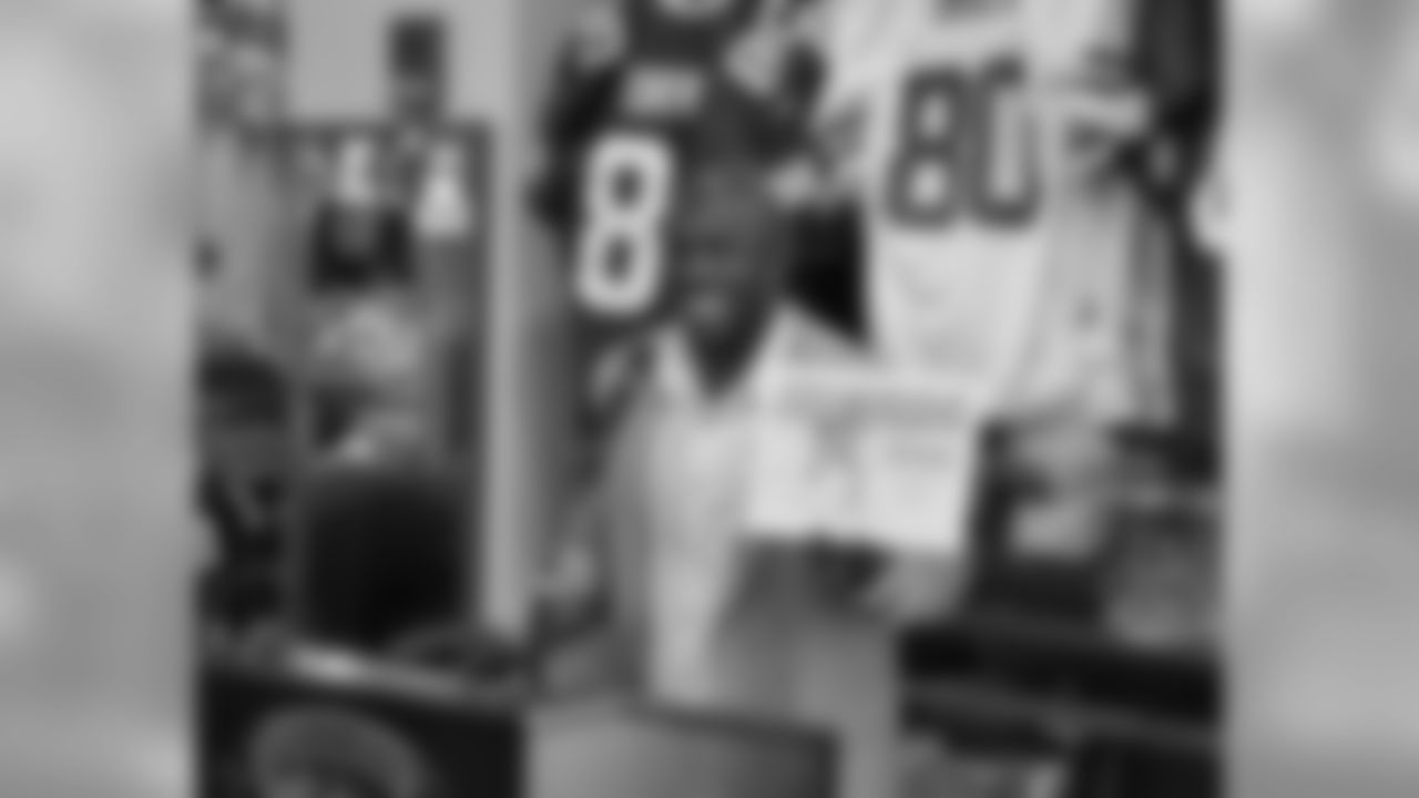 Donald Driver holds his children's book, 'Quickie Makes The Team'