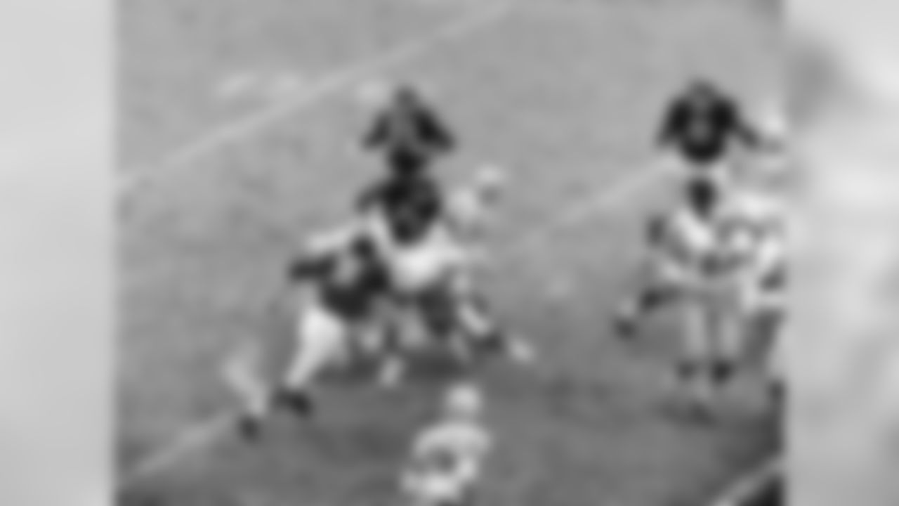 Dec. 4, 1960 - Packers HB Paul Hornung (5) finds running room for a six-yard gain against the Bears during the third quarter in Chicago. Packers G Fred "Fuzzy" Thurston (36) can be seen blocking Bears T Earl Leggett (71). The Packers won, 41-13. Other Packers visible are E Gary Knaflec and WR Boyd Dowler.