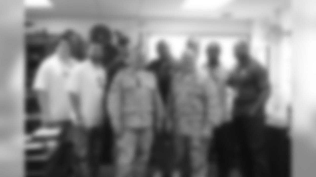 Players posing for a picture with Cmdr. Master Chief Maucieri and King in Okinawa, Japan.