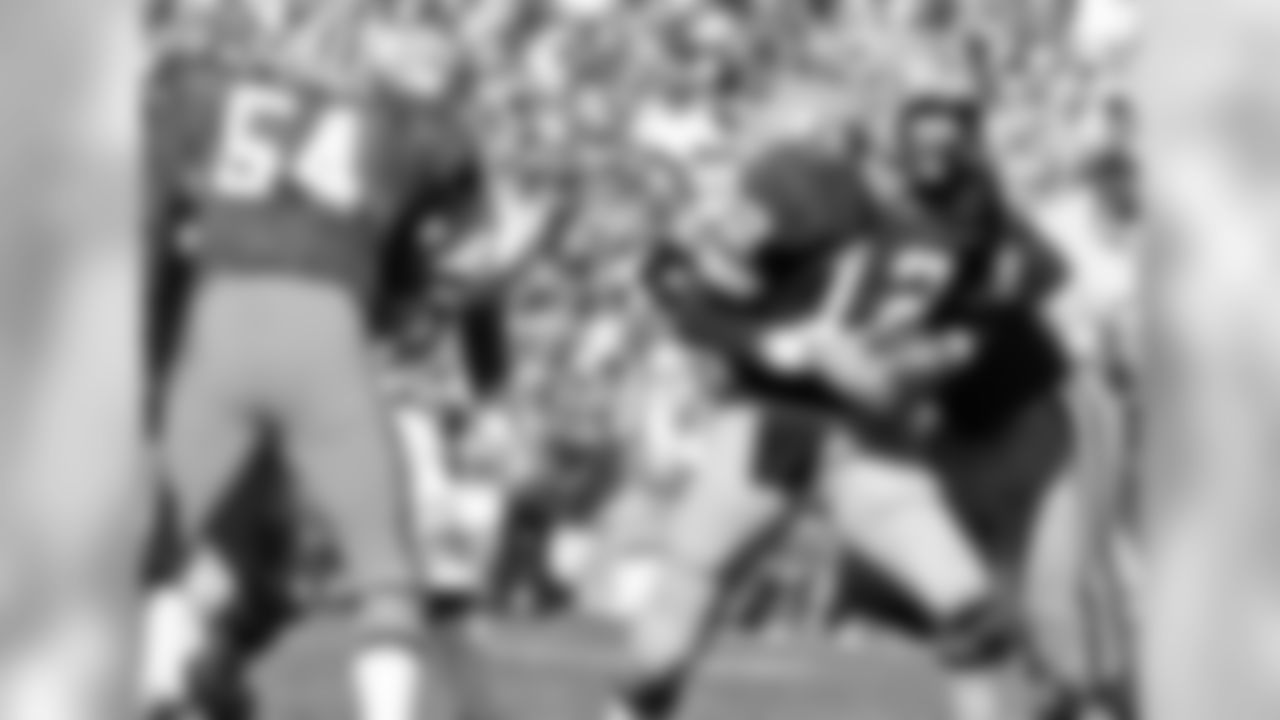 Packers C Larry McCarren (54) blocks for QB Lynn Dickey (12) during the first Packers-Bengals game in franchise history on October 3, 1971. The Packers beat the Bengals 20-17 at Lambeau Field.