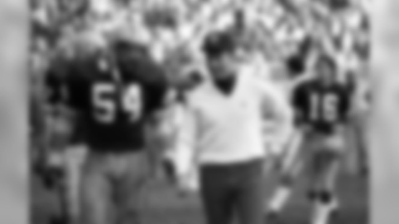 Nov. 22, 1982 - Head Coach Bart Starr talks with C Larry McCarren (54) as they walk across the field following the Packers' 26-7 victory over the Vikings in Milwaukee. The victory gave the Packers a 3-0 record in the strike-shortened season.