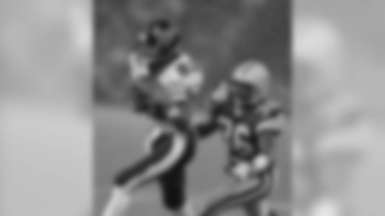 In a rainy preseason game in Baltimore on Aug. 17, 1996, WR Derrick Alexander hauls in a first quarter pass from Vinnie Testaverde as Packers S Leroy Butler closes in for the tackle. The downpour lasted throughout the contest.