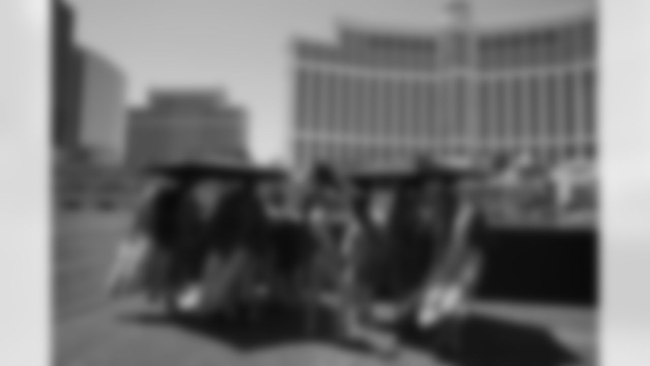 Showgirls pose for photos at The Fountains of Bellagio before the first round of the NFL football draft Thursday, April 28, 2022, in Las Vegas. (AP Photo/Jae C. Hong)