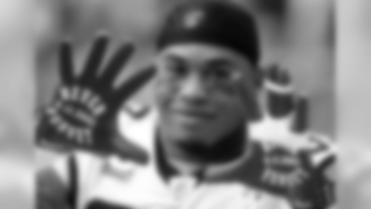 Carolina Panthers wide receiver Steve Smith displays his gloves prior to an NFL football game against the Arizona Cardinals, Sunday, Sept. 11, 2011, in Glendale, Ariz. Sunday was the 10th anniversary of the 9/11 attacks. (AP Photo/Ralph Freso)