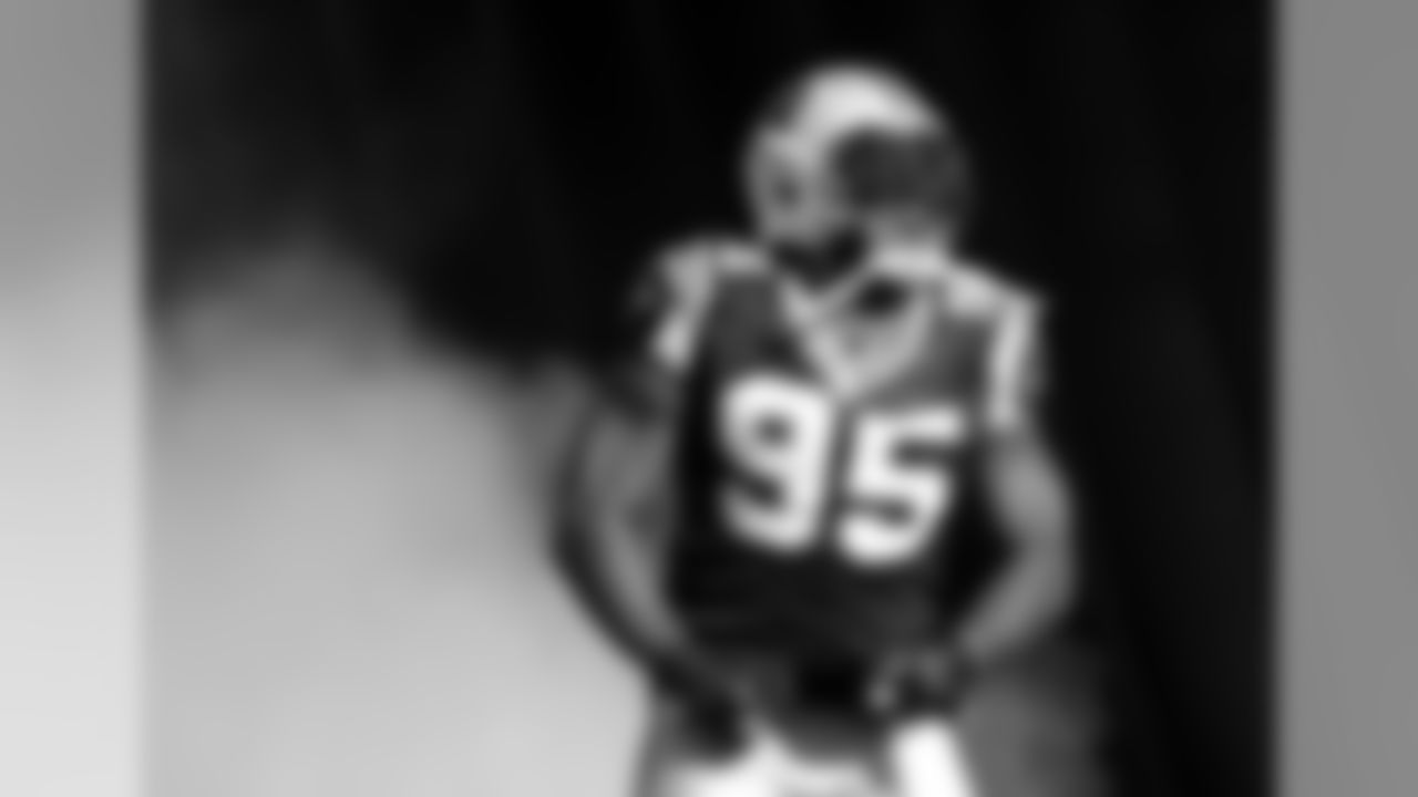 Carolina Panthers defensive end Charles Johnson shouts as he runs onto the field before an NFL football game against the Atlanta Falcons in Charlotte, N.C., Sunday, Dec. 11, 2011. (AP Photo/Nell Redmond)