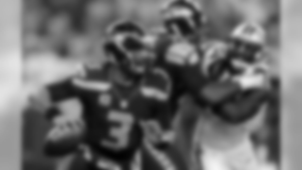 Seattle Seahawks quarterback Russell Wilson (3) scrambles against the Carolina Panthers during the first half of an NFL divisional playoff football game in Seattle, Saturday, Jan. 10, 2015. (AP Photo/John Froschauer)