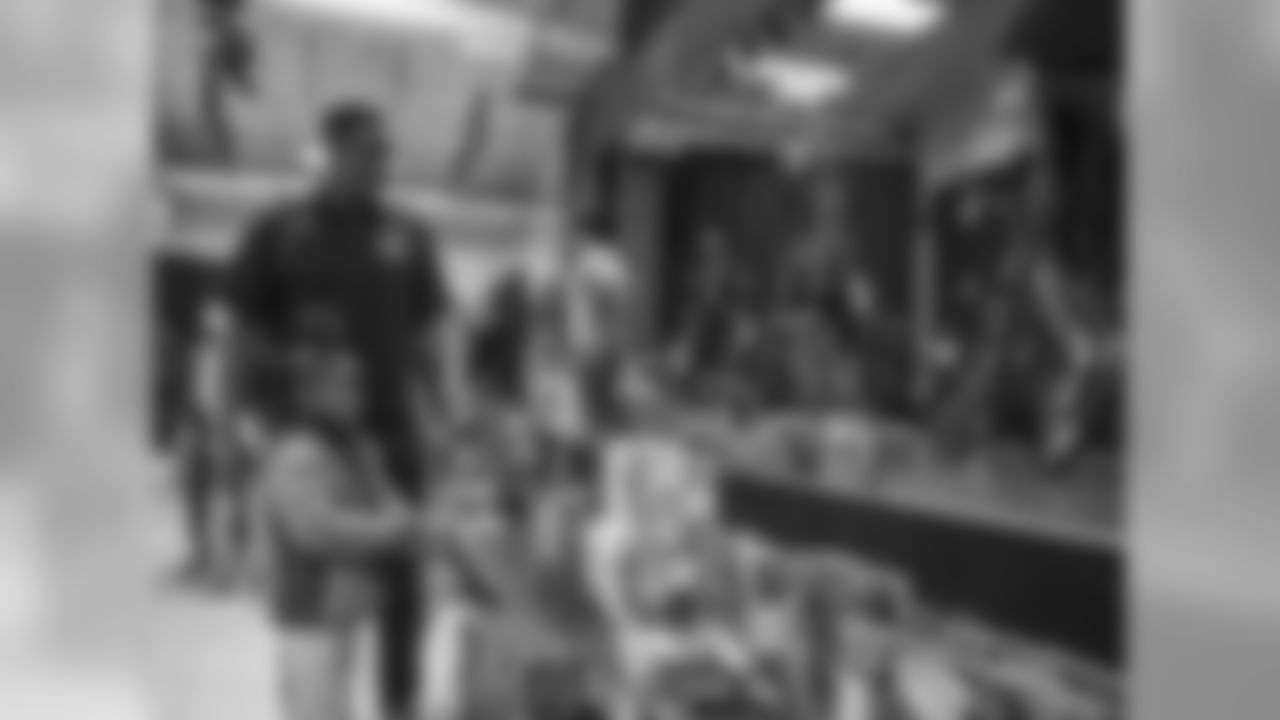 Thomas Davis and Mike Adams hand out toys to children on Tuesday, December 18, 2018.