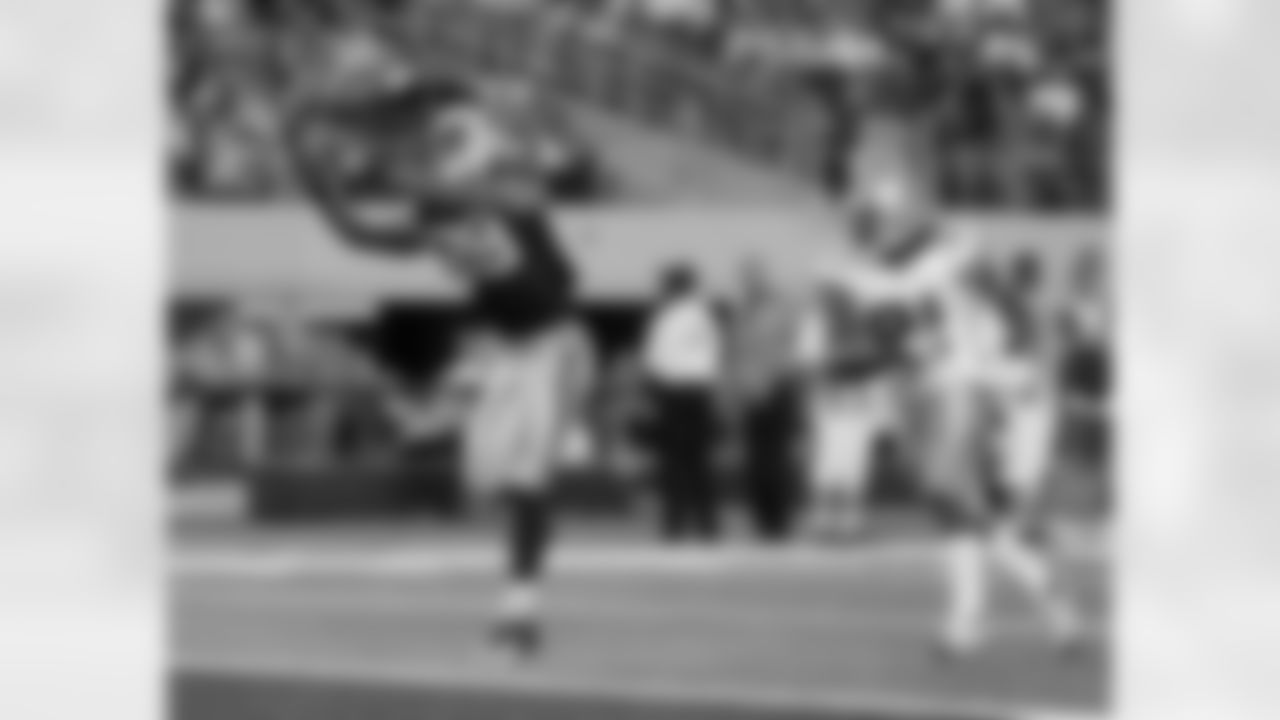 Carolina Panthers tight end Dante Rosario (88) reaches out for a touchdown pass as Dallas Cowboys cornerback Mike Jenkins (21) looks on.