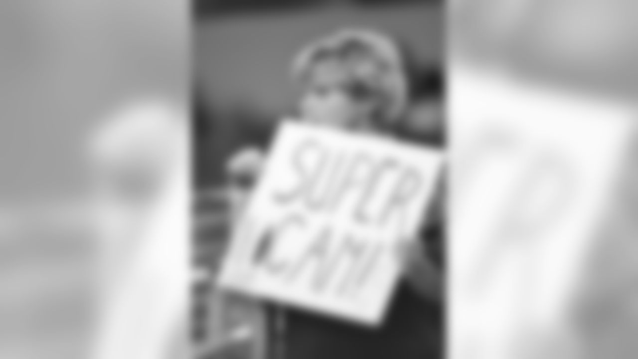A young fan holds a sign referencing Carolina Panthers' Cam Newton during an NFL football game against the Dallas Cowboys, Thursday, Nov. 26, 2015, in Arlington, Texas. (AP Photo/Michael Ainsworth)