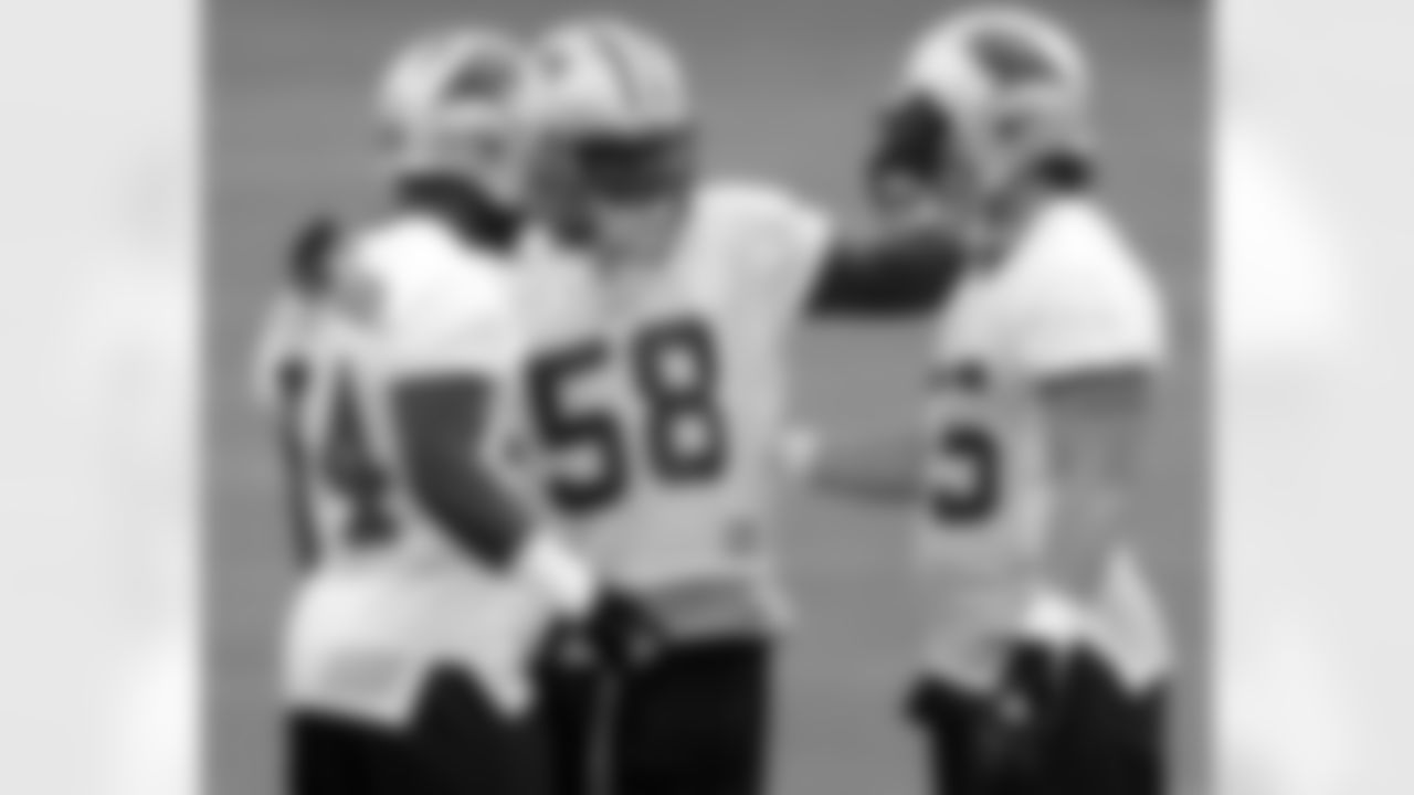 Carolina Panthers linebacker Mark Fields (58) jokes with teammates Dan Morgan (55) and Will Witherspoon (54) during the team's minicamp in Charlotte, N.C., Monday, June 14, 2004.
