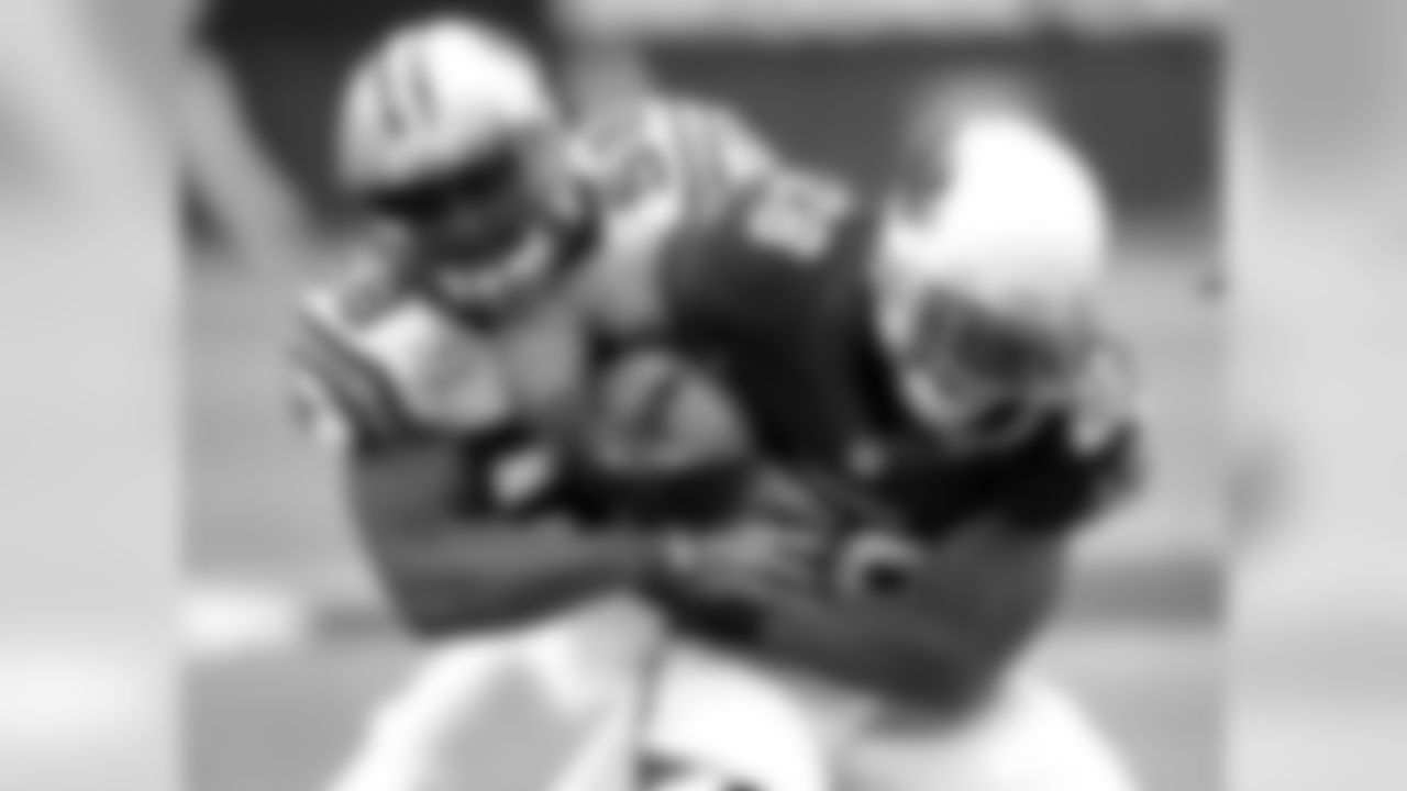 Arizona Cardinals running back Rashard Mendenhall (28) is tackled by Carolina Panthers outside linebacker Thomas Davis (58)during the first half of a NFL football game, Sunday, Oct. 6, 2013, in Glendale, Ariz. (AP Photo/Matt York)