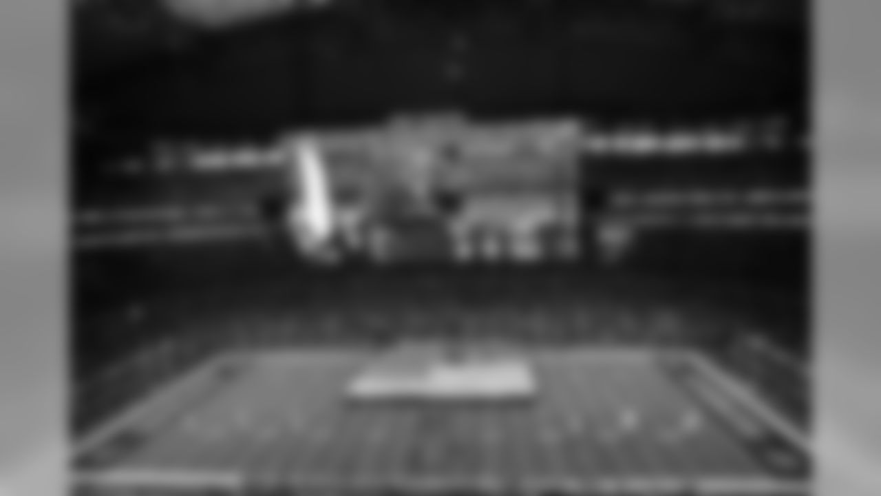 In a general, overall view of AT&T Stadium, trumpet player Freddie Jones is displayed on the large video screen playing the national anthem as members of the Salvation Army roll out a United States flag on the field before an NFL football game between the Carolina Panthers and the Dallas Cowboys, Thursday, Nov. 26, 2015, in Arlington, Texas. (AP Photo/Roger Steinman)