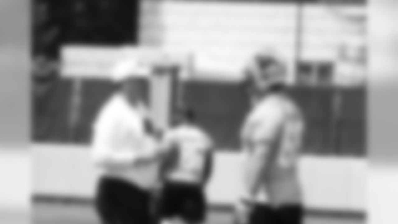 Rivera chats with left tackle Jordan Gross.