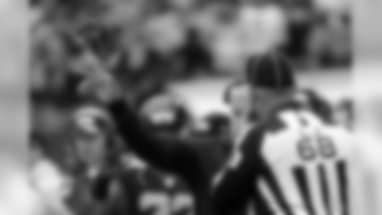 Seattle Seahawks head coach Pete Carroll tosses the challenge flag as he talks to line judge Tom Stephan (68) to challenge a call during an NFL football game against the Carolina Panthers, Sunday, Oct. 18, 2015, in Seattle. (AP Photo/Elaine Thompson)