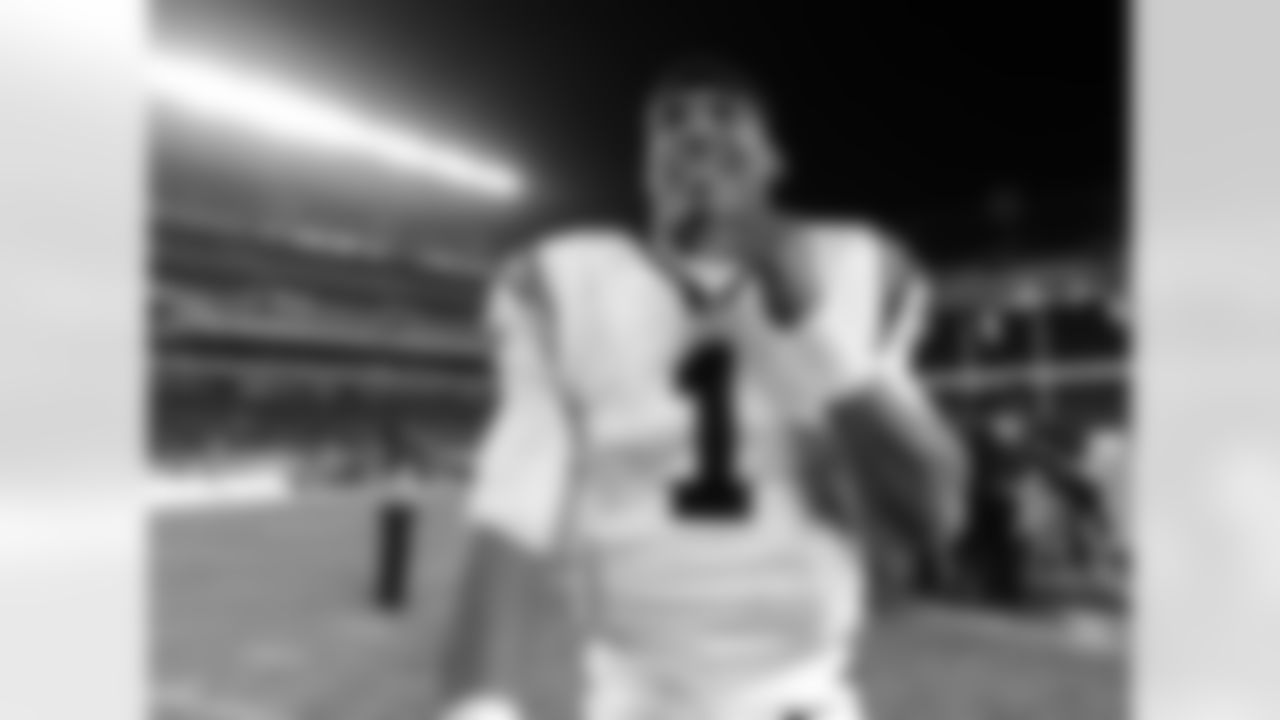 Carolina Panthers quarterback Cam Newton smiles as he walks off the field after an NFL football game against the Philadelphia Eagles, Monday, Nov. 26, 2012, in Philadelphia. Carolina won 30-22. (AP Photo/Michael Perez)
