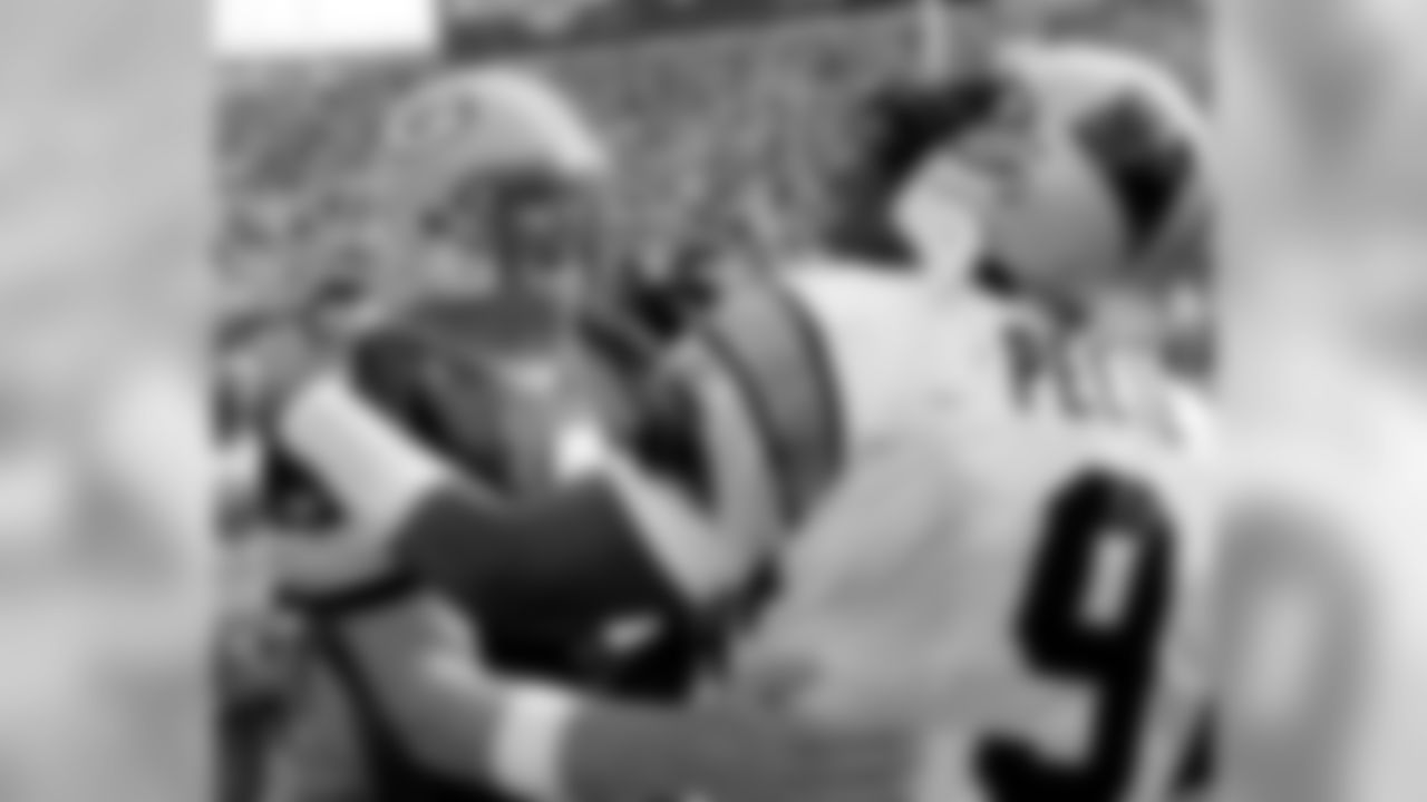 Carolina Panthers quarterback Rodney Peete (9) hugs Green Bay Packers quarterback Brett Favre following their game Sunday, Sept. 29, 2002, in Green Bay, Wis. The Packers won 17-14. (AP Photo/Morry Gash)