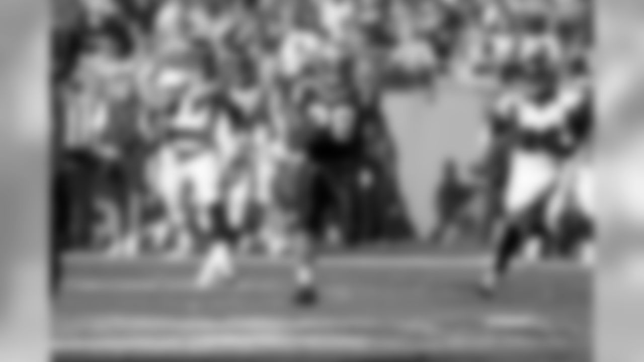 Stewart charges up the middle for a big gain versus the Denver Broncos.