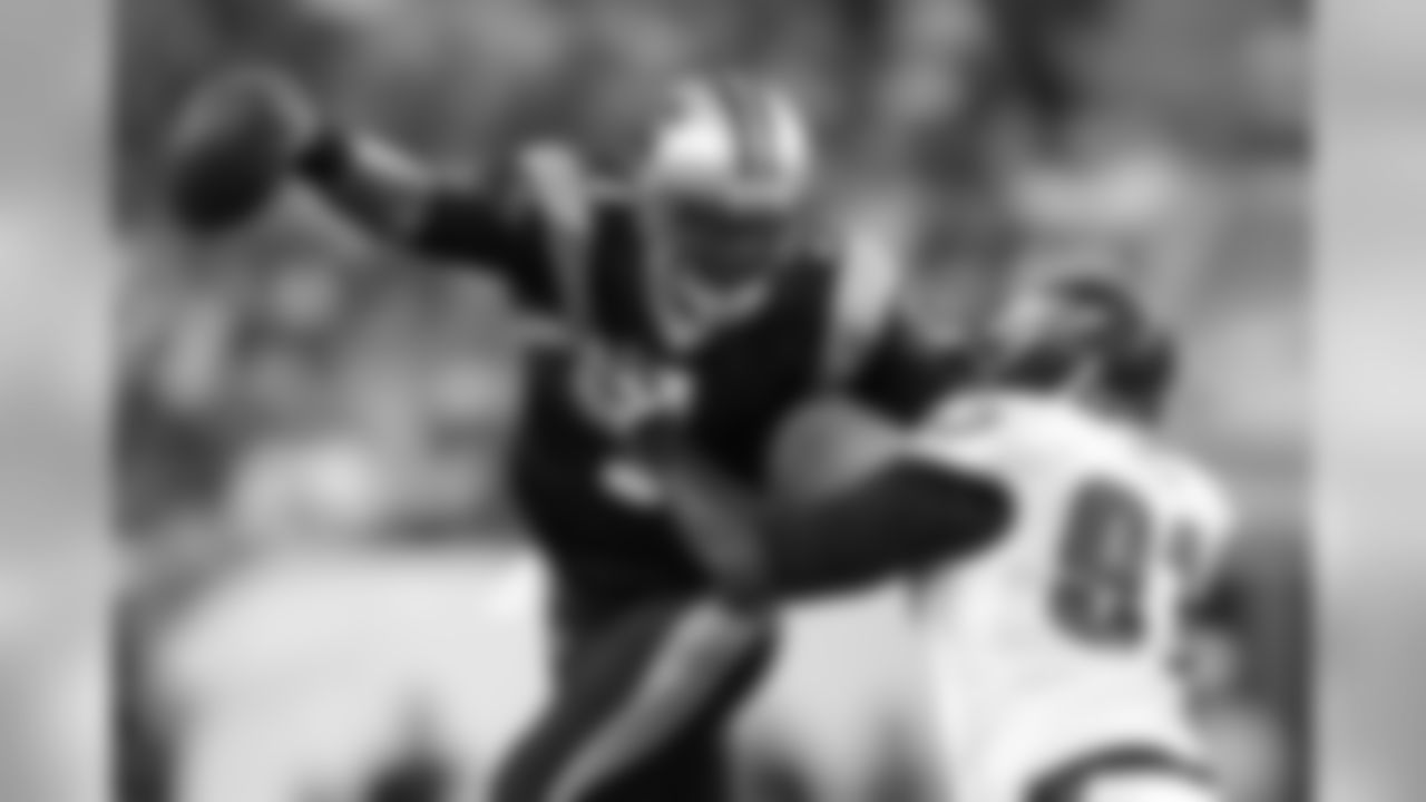 Carolina Panthers quarterback Cam Newton, left, tries to slip away from Philadelphia Eagles defensive tackle Fletcher Cox during the first half of a preseason NFL football game, Thursday, Aug. 15, 2013, in Philadelphia. (AP Photo/Matt Rourke)
